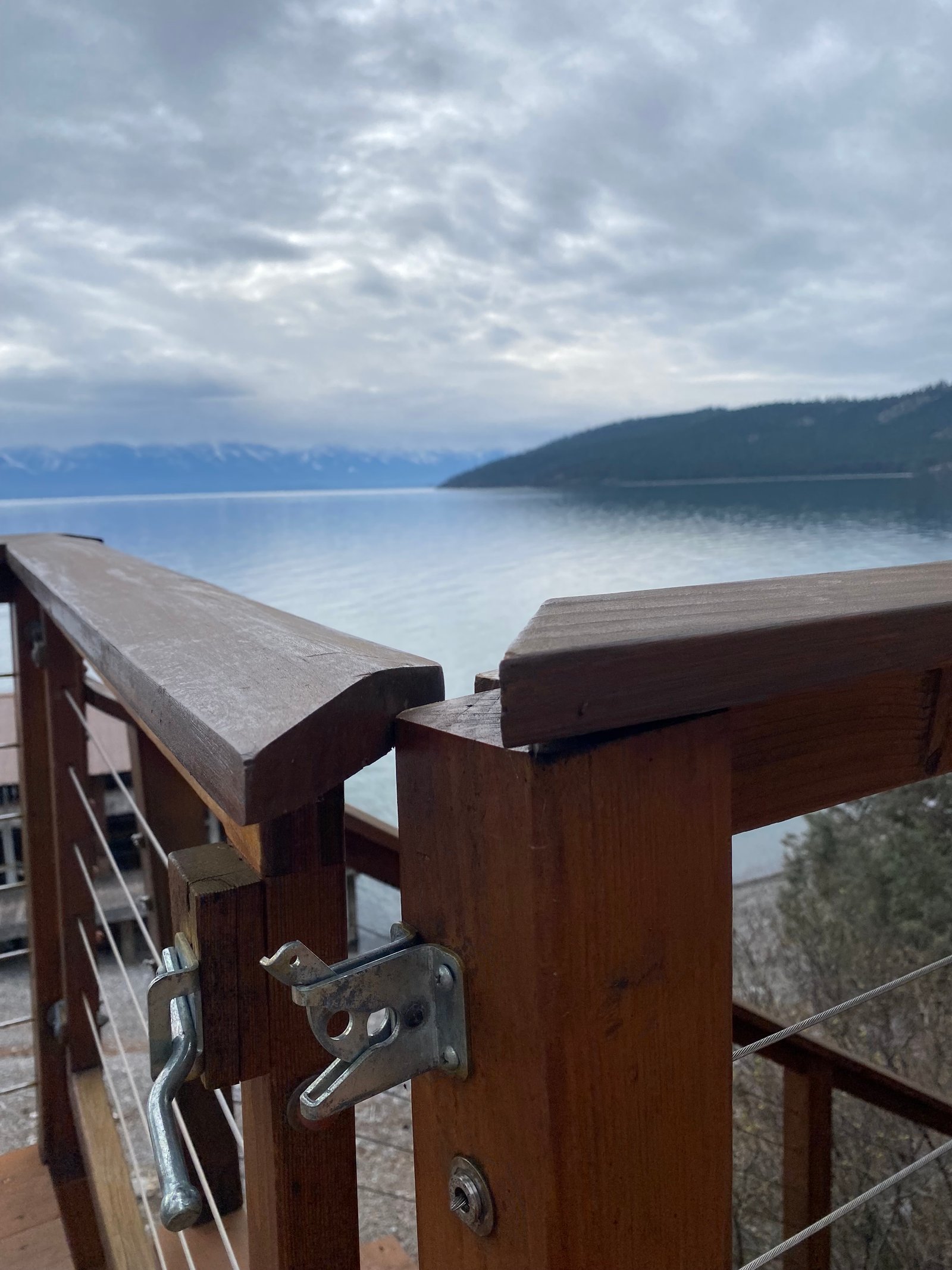 Before photo of deck gate latch and railing repair by the lake